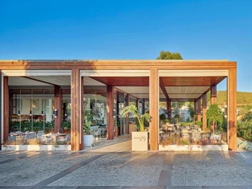 a large building with glass doors and windows at Voyage Torba Hotel in Torba