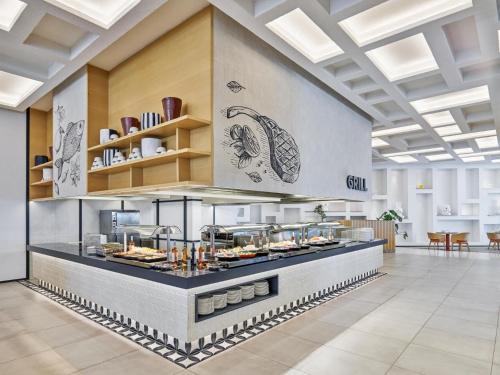a restaurant with a buffet of food at Voyage Torba Hotel in Torba