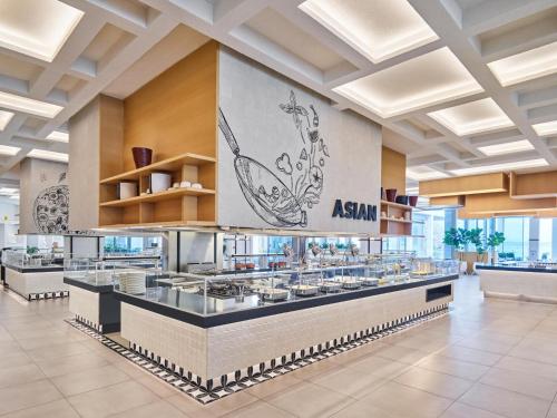 an asian restaurant with a buffet line in a building at Voyage Torba Hotel in Torba