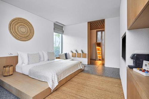 a bedroom with a large bed and a tv at Voyage Torba Hotel in Torba