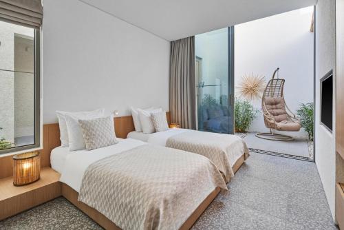 a hotel room with two beds and a chair at Voyage Torba Hotel in Torba