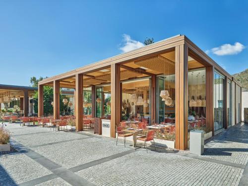 a building with tables and chairs outside of it at Voyage Torba Hotel in Torba