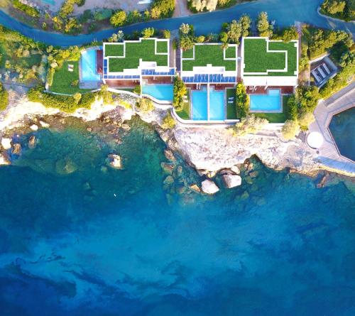 an aerial view of a resort with blue water at Grand Resort Lagonissi in Lagonissi