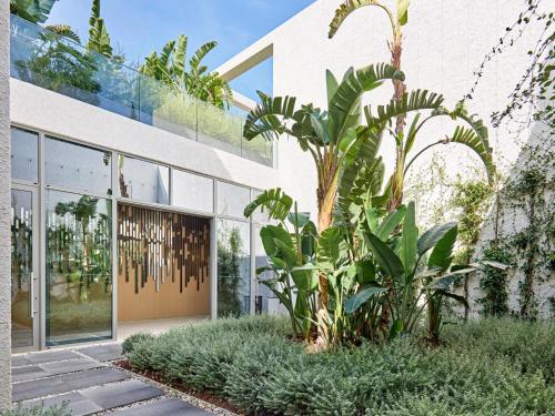 a building with plants in front of it at Voyage Torba Hotel in Torba