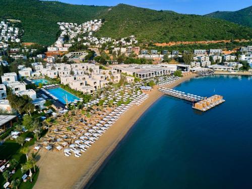 an aerial view of a beach with a resort at Voyage Torba Hotel in Torba
