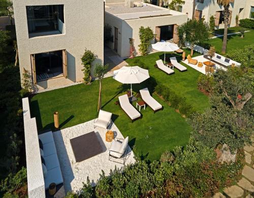 an overhead view of a backyard with chairs and umbrellas at Voyage Torba Hotel in Torba
