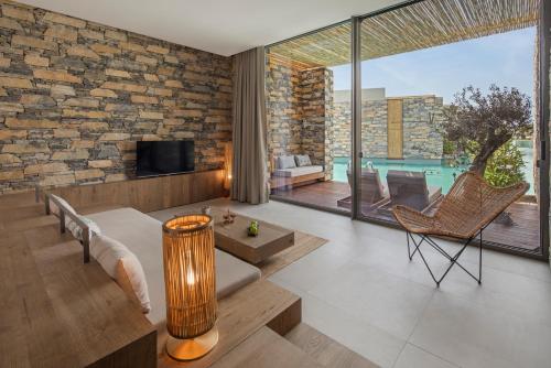 a living room with a brick wall at Voyage Torba Hotel in Torba