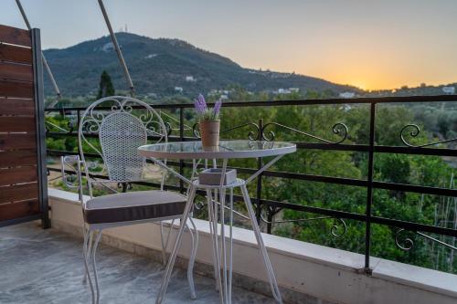 a table and chairs on a balcony with a view at Filoxenia Apartments in Mytilini