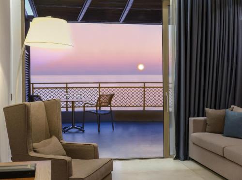 a living room with a view of the ocean at Nana Golden Beach All Inclusive Resort & Spa in Hersonissos