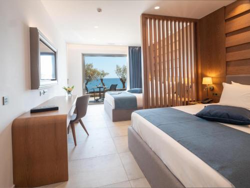a hotel room with a bed and a desk and a bedroom at Nana Golden Beach All Inclusive Resort & Spa in Hersonissos