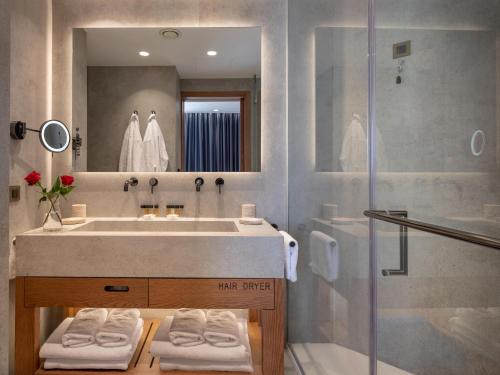 a bathroom with a sink and a shower at Nana Golden Beach All Inclusive Resort & Spa in Hersonissos
