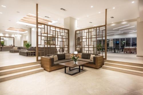 a lobby of a building with couches and a table at Nana Golden Beach All Inclusive Resort & Spa in Hersonissos