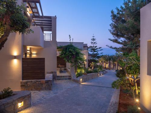 a pathway leading to a house at night at Nana Golden Beach All Inclusive Resort & Spa in Hersonissos