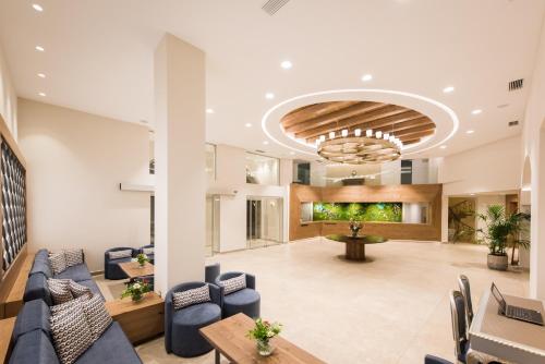 a lobby with blue chairs and a table at Nana Golden Beach All Inclusive Resort & Spa in Hersonissos
