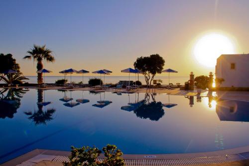 a swimming pool with the sun setting in the background at Nana Golden Beach All Inclusive Resort & Spa in Hersonissos