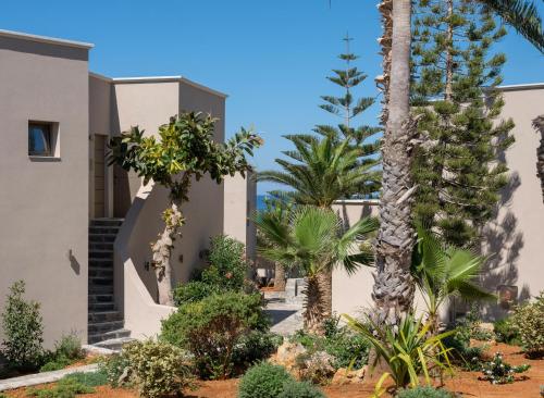 a view of the front of a building with palm trees at Nana Golden Beach All Inclusive Resort & Spa in Hersonissos