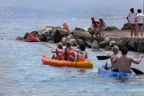 a group of people in kayaks in the water at Nana Golden Beach All Inclusive Resort & Spa in Hersonissos