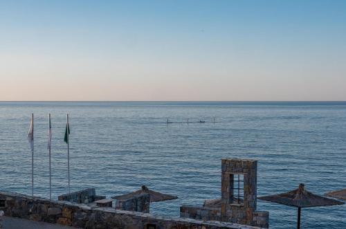 a large body of water with umbrellas and the ocean at Nana Golden Beach All Inclusive Resort & Spa in Hersonissos