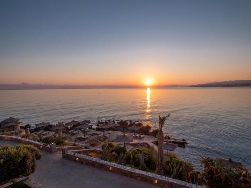 an aerial view of a resort on the water at sunset at Nana Golden Beach All Inclusive Resort & Spa in Hersonissos