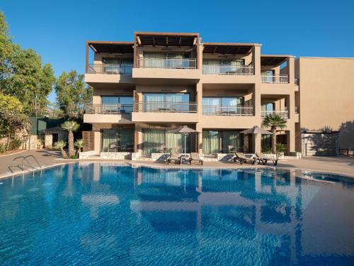 a large swimming pool in front of a building at Nana Golden Beach All Inclusive Resort & Spa in Hersonissos