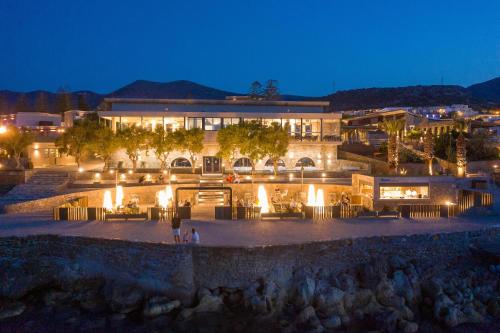 a building with lights in front of it at night at Nana Golden Beach All Inclusive Resort & Spa in Hersonissos