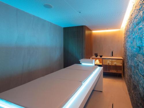 a room with a white bed and a blue ceiling at Nana Golden Beach All Inclusive Resort & Spa in Hersonissos
