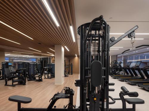 a gym with a lot of treadmills and machines at Nana Golden Beach All Inclusive Resort & Spa in Hersonissos