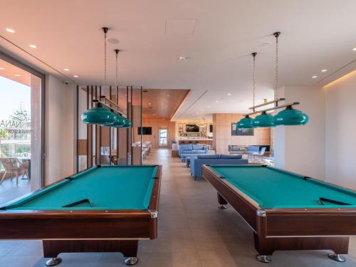 a pool table in a room with couches at Nana Golden Beach All Inclusive Resort & Spa in Hersonissos