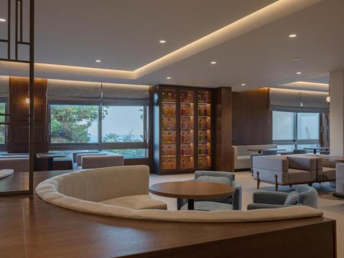 a living room with a couch and chairs and a table at Nana Golden Beach All Inclusive Resort & Spa in Hersonissos