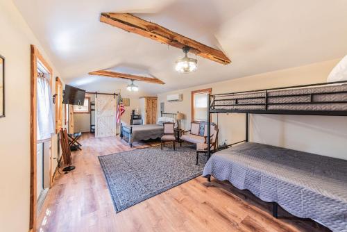 a bedroom with a bunk bed and a living room at The Outpost in Grand Rivers