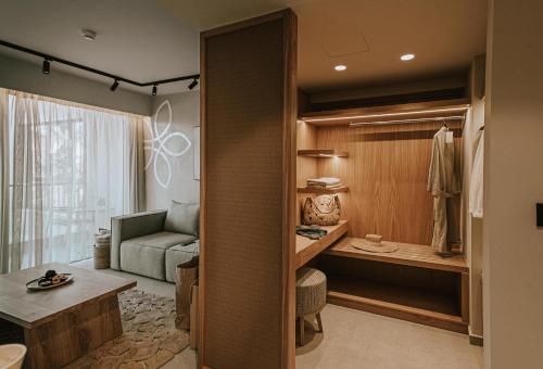 a small living room with a couch and a bedroom at Unique Blue! Resort and Villas Adults Only in Karteros