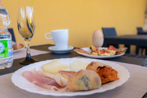 a table with a plate of food and a glass of wine at Tenuta San Lorenzo in Otranto