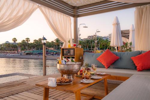 a living room with a couch and a table at Sidera Kirman Premium - Ultra All Inclusive in Okurcalar
