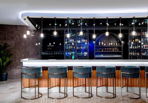 a bar with blue stools in a room at Leodikya Kirman Premium - Ultra All Inclusive in Okurcalar