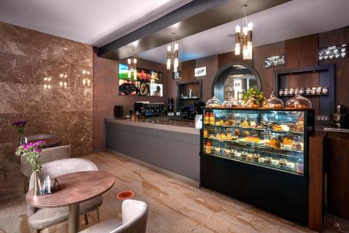 a restaurant with a counter and a bakery at Leodikya Kirman Premium - Ultra All Inclusive in Okurcalar