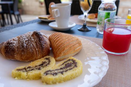 a white plate with two pastries on a table at Tenuta San Lorenzo in Otranto
