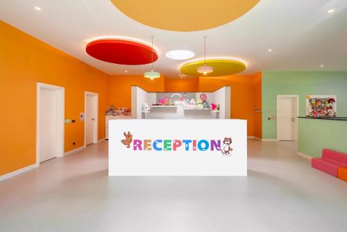 a room with orange walls and a pretend reception counter at Leodikya Kirman Premium - Ultra All Inclusive in Okurcalar