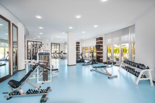 a gym with a blue floor and treadmills at Leodikya Kirman Premium - Ultra All Inclusive in Okurcalar