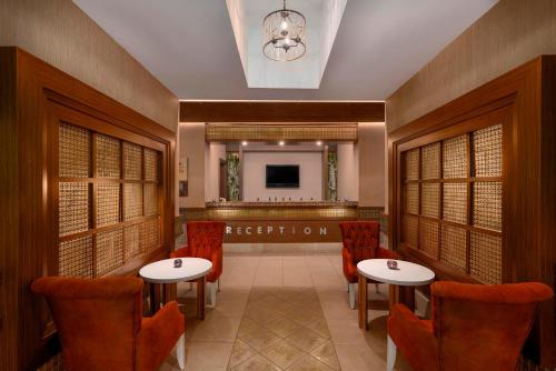a restaurant with two tables and chairs and a television at Leodikya Kirman Premium - Ultra All Inclusive in Okurcalar