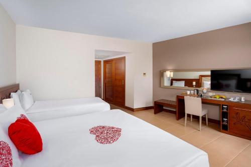 a hotel room with two beds and a television at Leodikya Kirman Premium - Ultra All Inclusive in Okurcalar