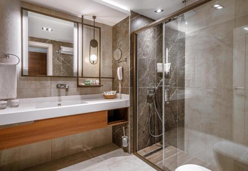 a bathroom with a shower and a sink at Leodikya Kirman Premium - Ultra All Inclusive in Okurcalar