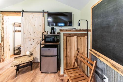a classroom with a blackboard and a chair and a table at The Outpost in Grand Rivers