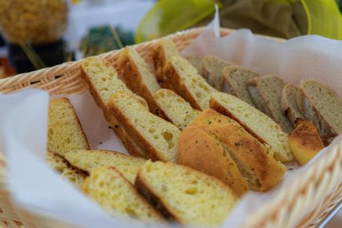 a basket filled with slices of bread on a table at Tenuta San Lorenzo in Otranto