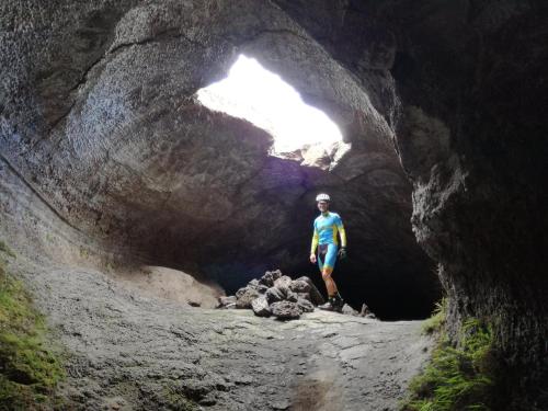 a man standing inside of a cave at Ai Tre Parchi Bed And Bike in Randazzo