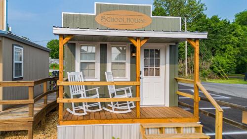 a tiny house with two chairs on a deck at The Outpost in Grand Rivers