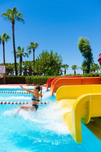 a woman on a water slide at a water park at Miramare Beach Hotel - Ultra All Inclusive in Side