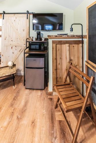 a kitchen with a stove and a chair in a room at The Outpost in Grand Rivers