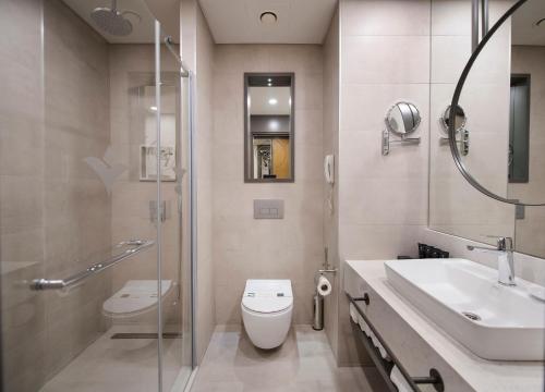 a bathroom with a toilet and a sink and a shower at Miramare Beach Hotel - Ultra All Inclusive in Side