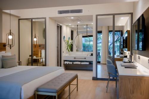 a bedroom with a large bed and a bathroom at Miramare Beach Hotel - Ultra All Inclusive in Side