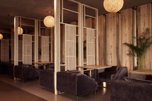 a room with a row of tables and chairs at NEMA Design Hotel & Spa - Adults Only in Hersonissos